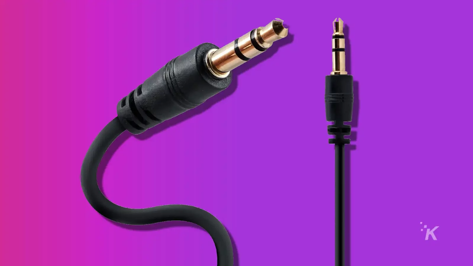 Aux-Kabel für einen JBL-Lautsprecher zum Anschluss an einen PC auf violettem Hintergrund