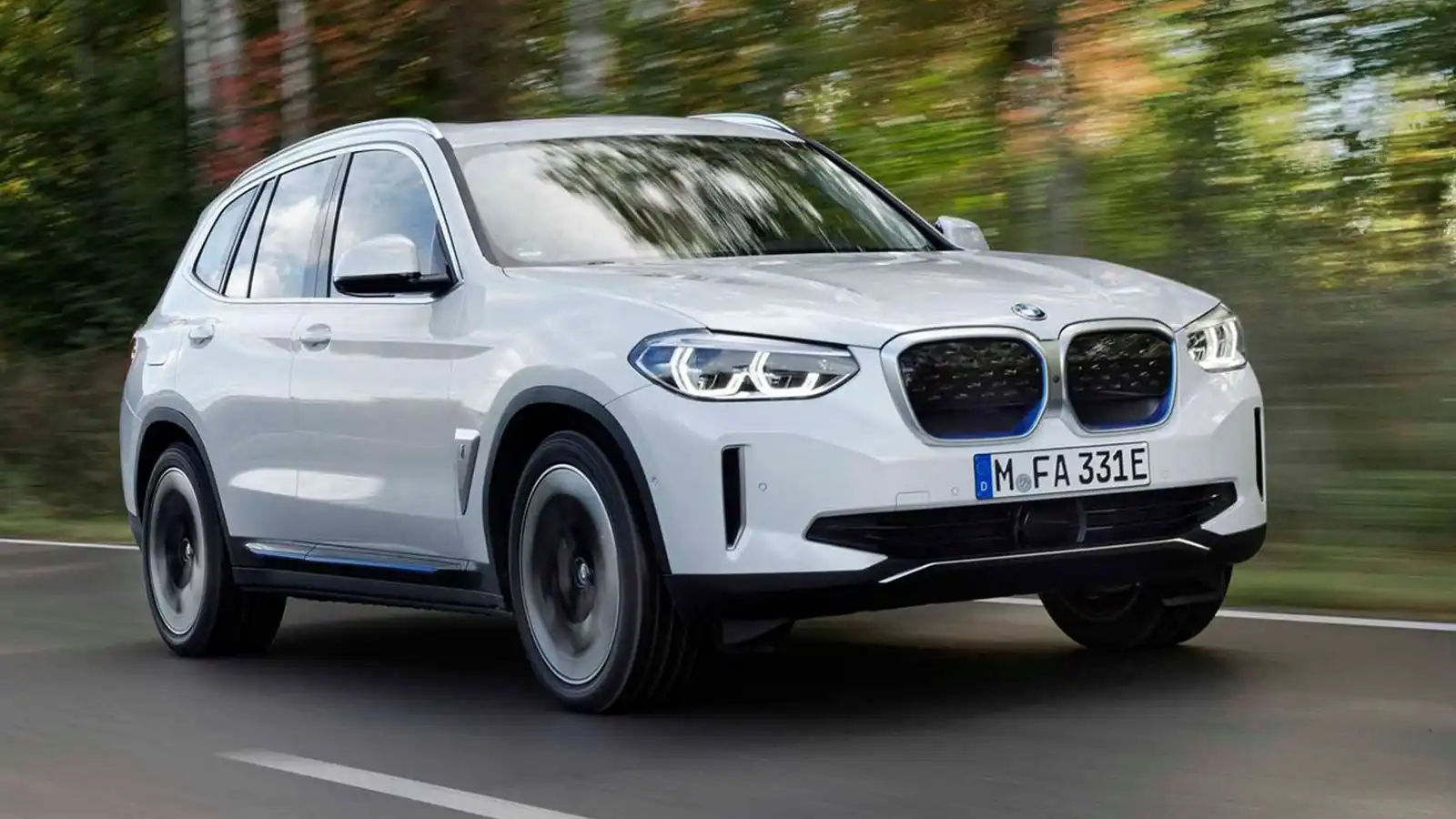 BMW iX3 putih di jalan.