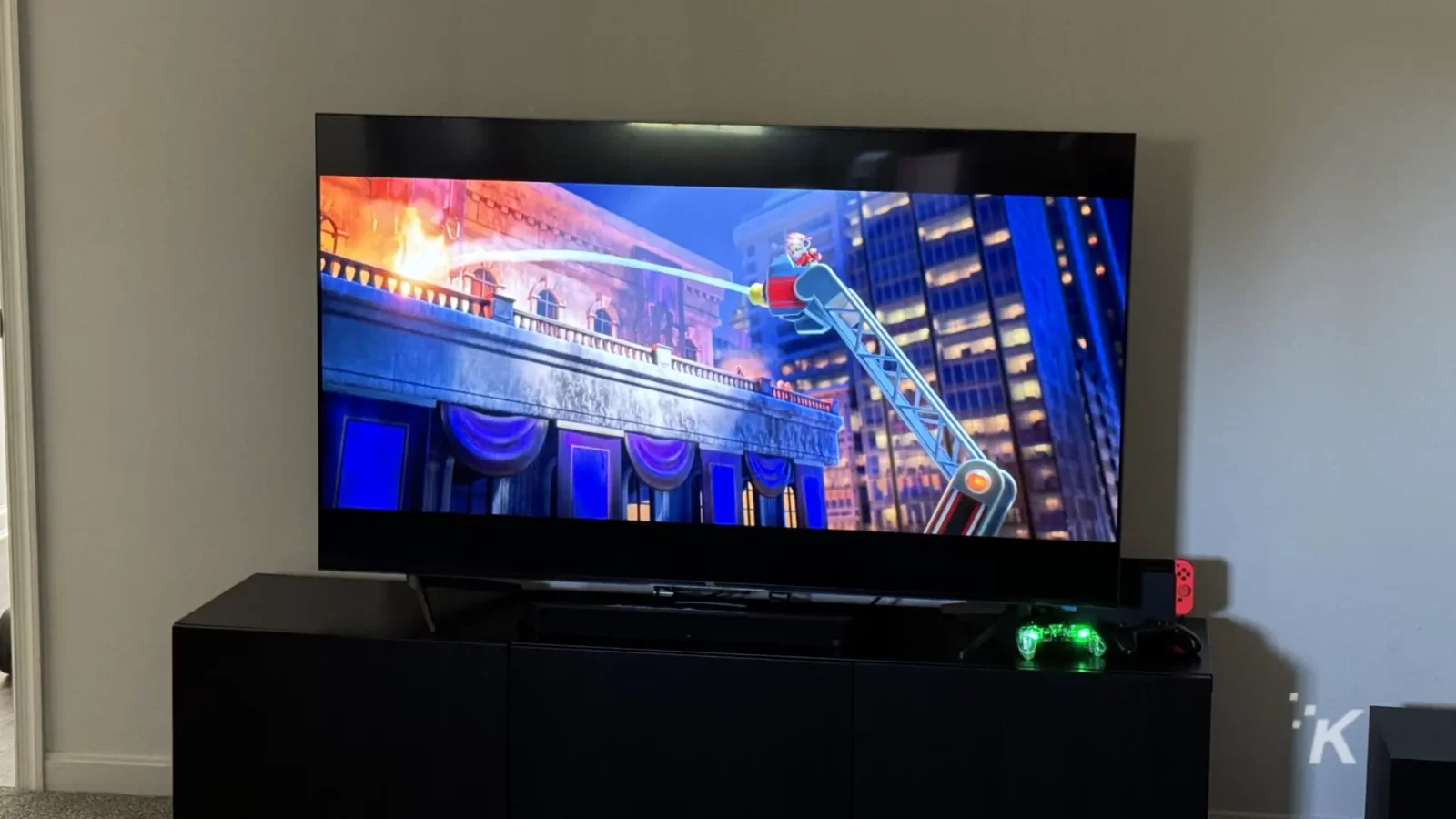 Tcl q7 65-inch qled tv on a cabinet