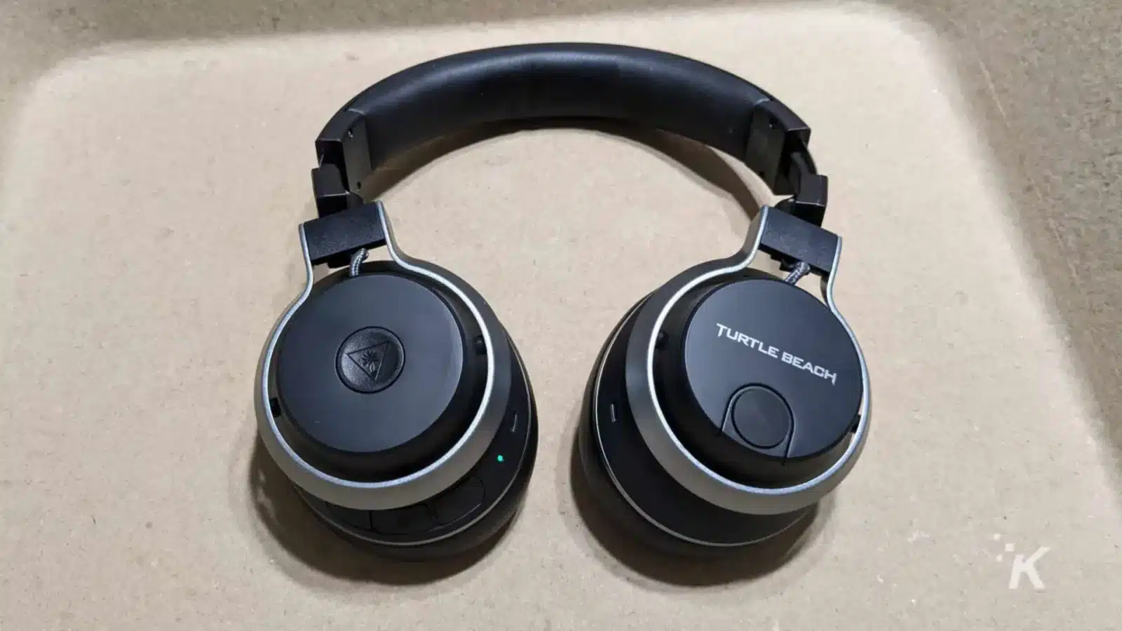 A headset with headphones and ear pads is connected to an electronic device, providing audio through turtle beach k headphones.