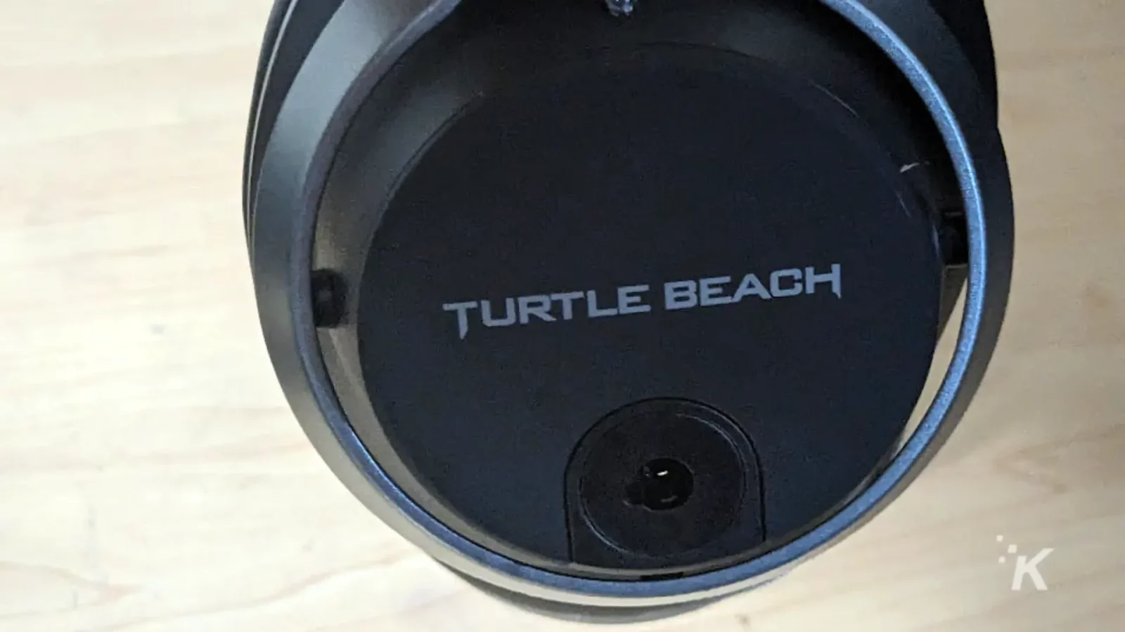 A circular lens sits atop a turtle beach k headset.