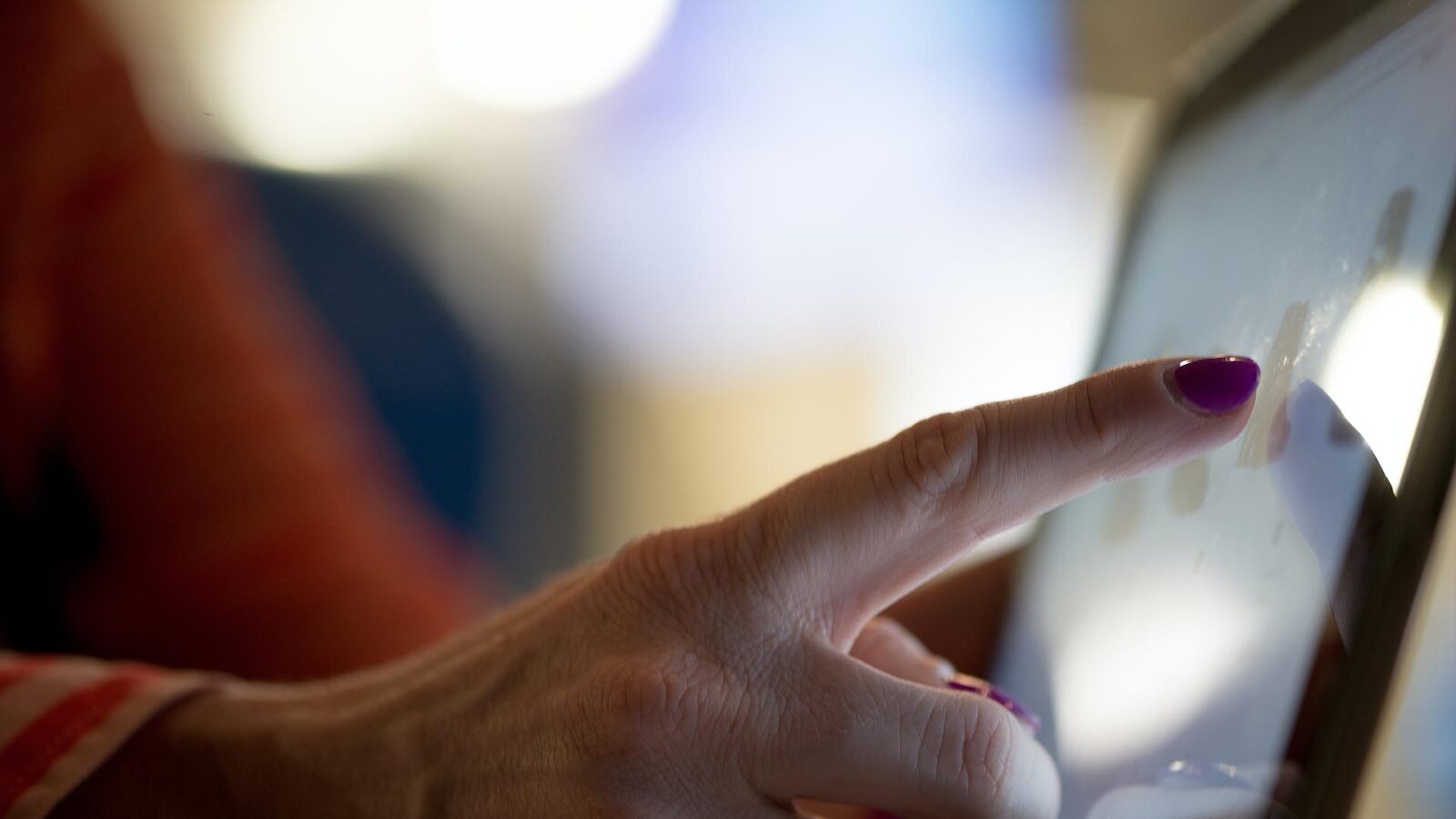 A person touching a screen with haptic feedback