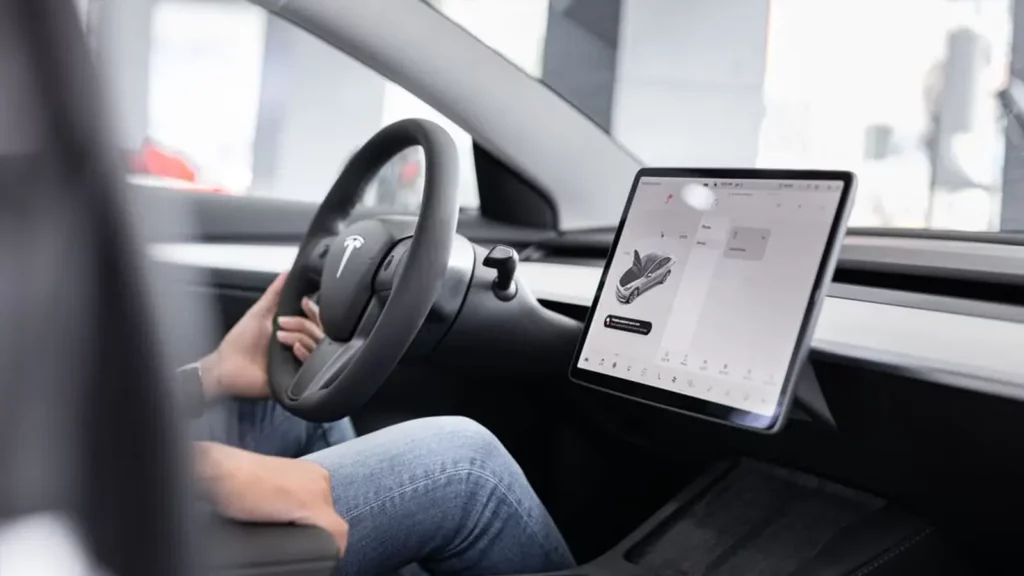 Interior of a tesla with a person driving