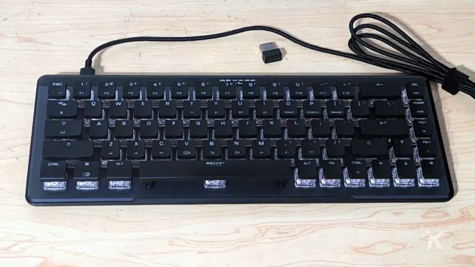 Roccat vulkan ii mini air mechanical keyboard next to usb dongle