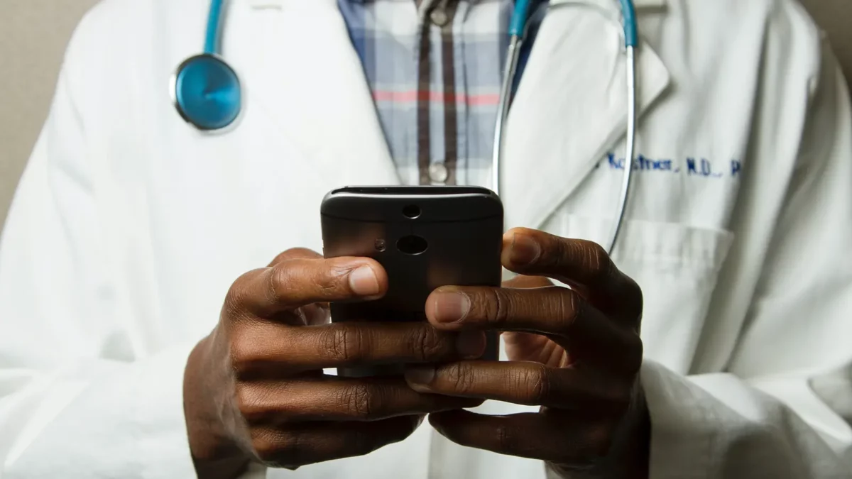 Healthcare worker looking at his phone app