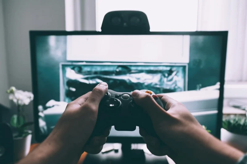 game controller in front of a computer monitor.